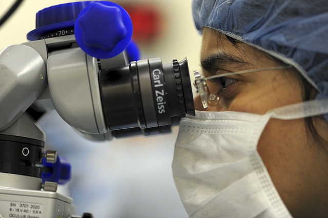 Researcher using a microscope