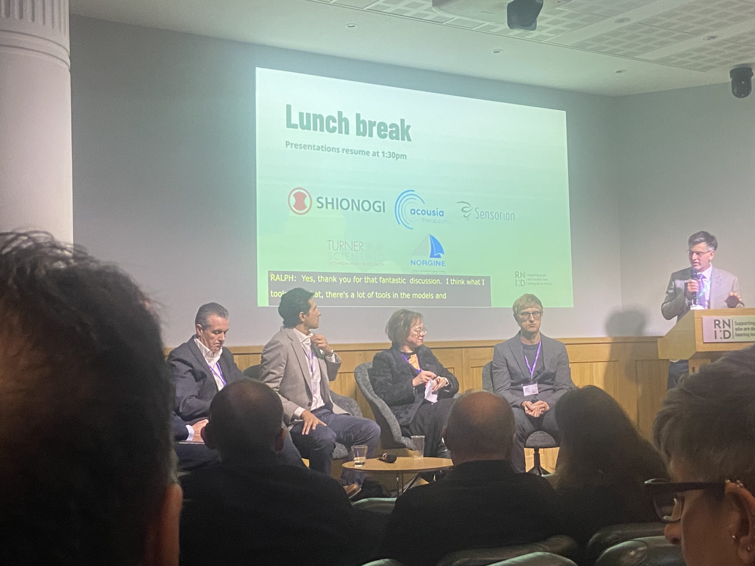 Panellists speaking on stage